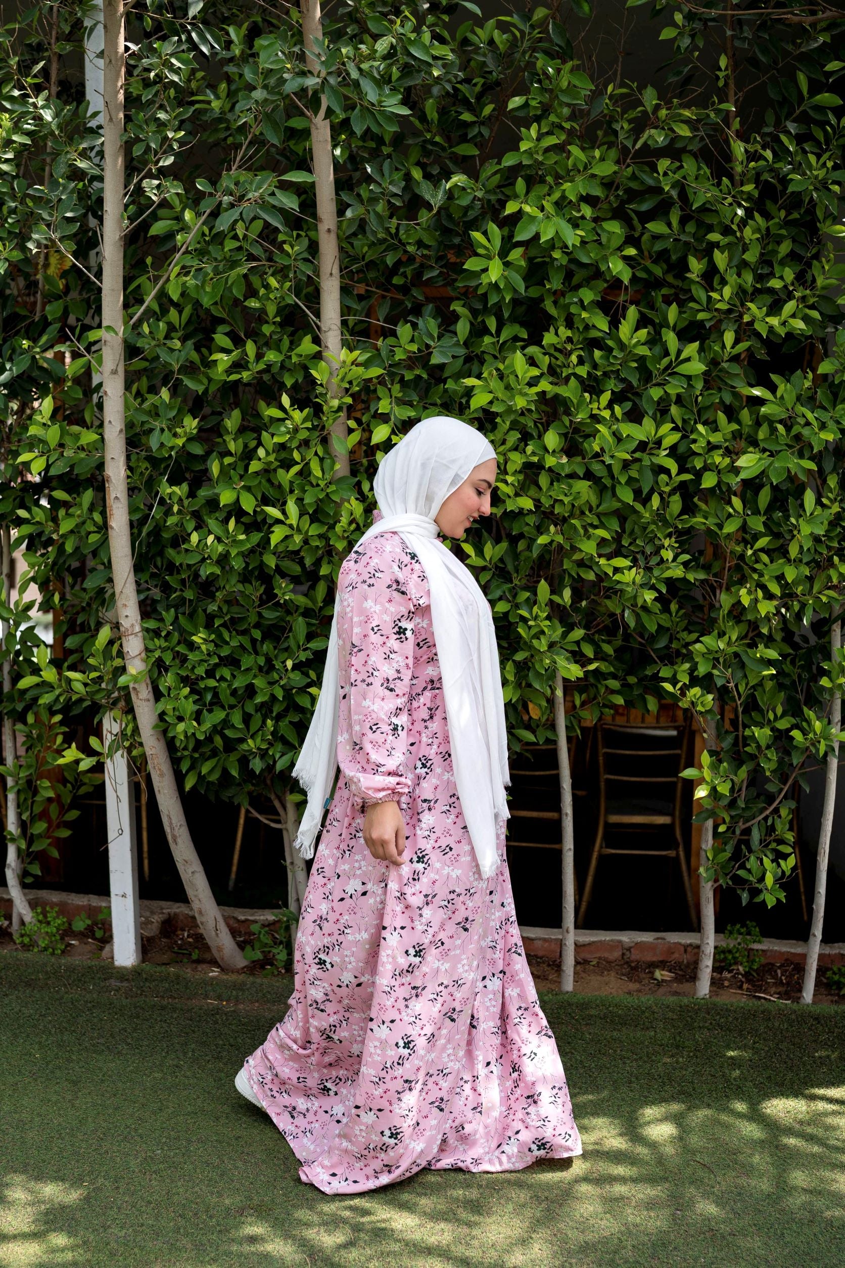 Side view of Spring Dress in Pink showing the floral pattern and long sleeves. فستان ربيعي باللون الوردي بنمط زهور وأكمام طويلة، منظر جانبي